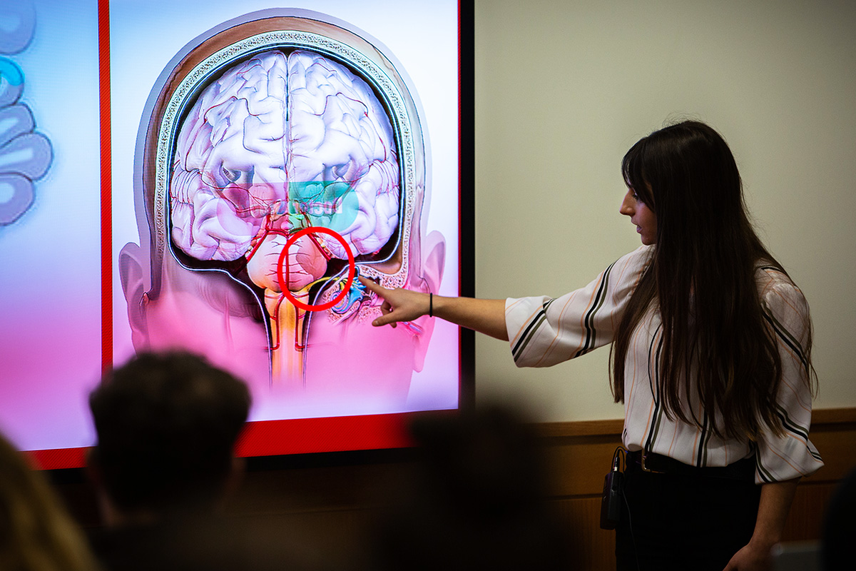 A student presents research at a community event.